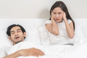 man snoring due to oral health and sleep issues