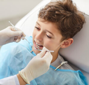 younger kid at the dentist getting a checkup